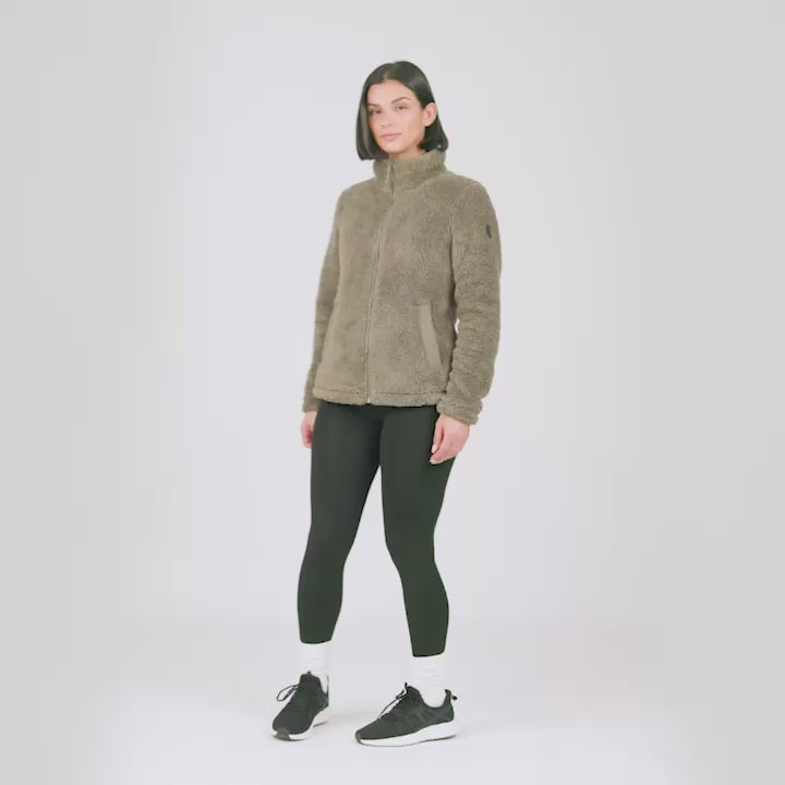 Model wearing the Women's Sierra Sherpa Pile® Zip Up Jacket in olive brown sherpa, worn with black leggings