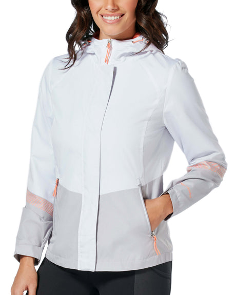 A woman smiles with one hand in her pocket, wearing the Clearance Women's Sporty Multi Ripstop Jacket in light gray and white with orange zippers, a high collar, long sleeves, and subtle stripe details.