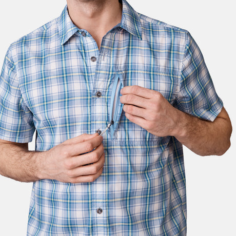 [Will is 6'2" wearing a size Medium.] Man is wearing Men's Excursion Short Sleeve Poplin Shirt in Vintage Cream Plaid, size M, made from lightweight moisture wicking polyester fabric featuring vent at the back, full button down front, and a stand collar, styled with brown shorts #color_vintage-cream