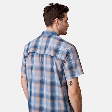 [Will is 6'2" wearing a size Medium.] Man is wearing Men's Excursion Short Sleeve Poplin Shirt in Dried Sage Plaid, size M, made from lightweight moisture wicking polyester fabric featuring vent at the back, full button down front, and a stand collar, styled with brown shorts #color_dried-sage