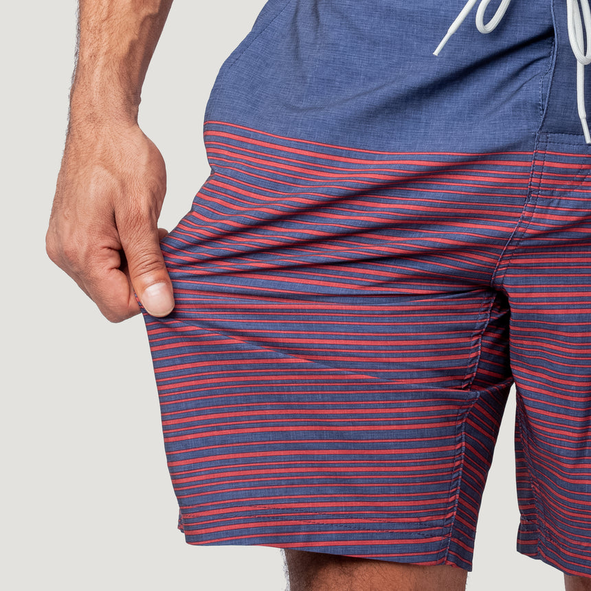 [Model is wearing a size Medium.] Men's Lake Side Stripe Surf Short - Redrock #color_redrock