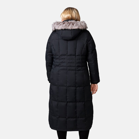 [Lola is 5'10.5" wearing a size 1X.] Woman wearing Free Country Women's Plus Size Full Length Splendor Down Jacket in black with a full front zipper opening, lower pockets, calf length, a detachable hood with faux fur trim, and water resistant and wind resistant stretch performance fabric, light grey background. Best women’s jacket for winter weather.