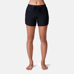 [Model is 5’9” wearing a size Small.] Woman wearing Free Country Women's 5" Bermuda Board Short in Black, size S, made from quick drying UPF stretch performance fabric featuring a fly front zipper closure with a drawcord and two front pockets 